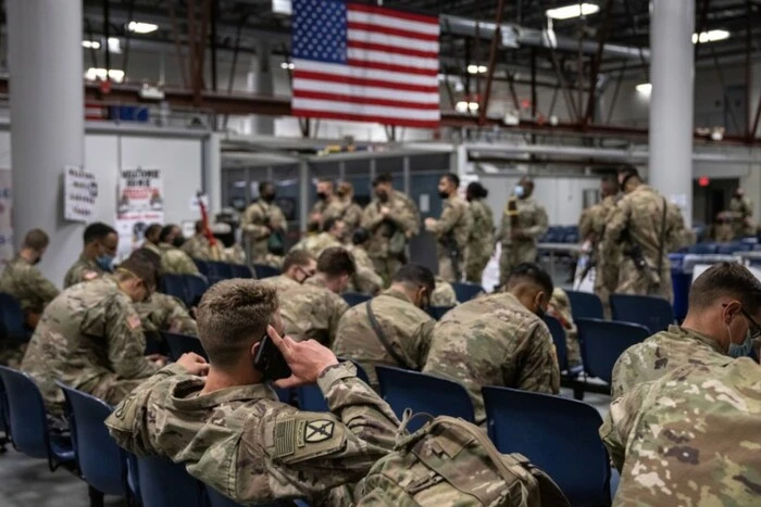 Soldier in uniform with a transgender flag
